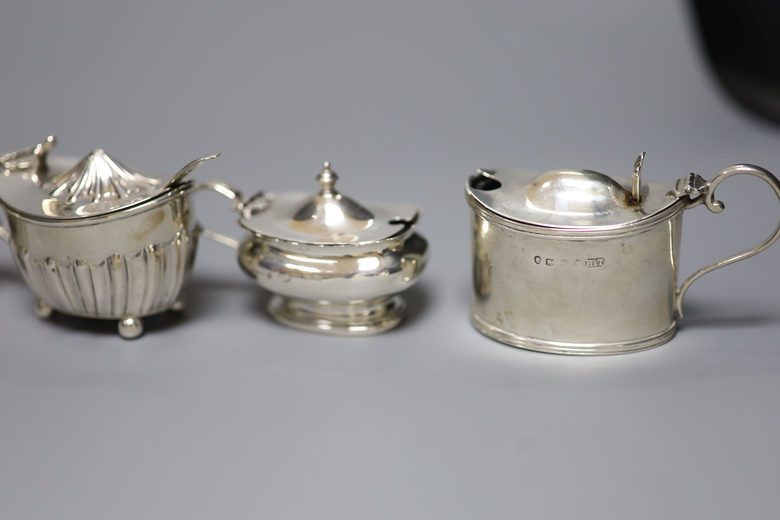 An ornate silver circular mustard with ruby glass liner and six other silver mustards, Victorian and later, approx 12oz